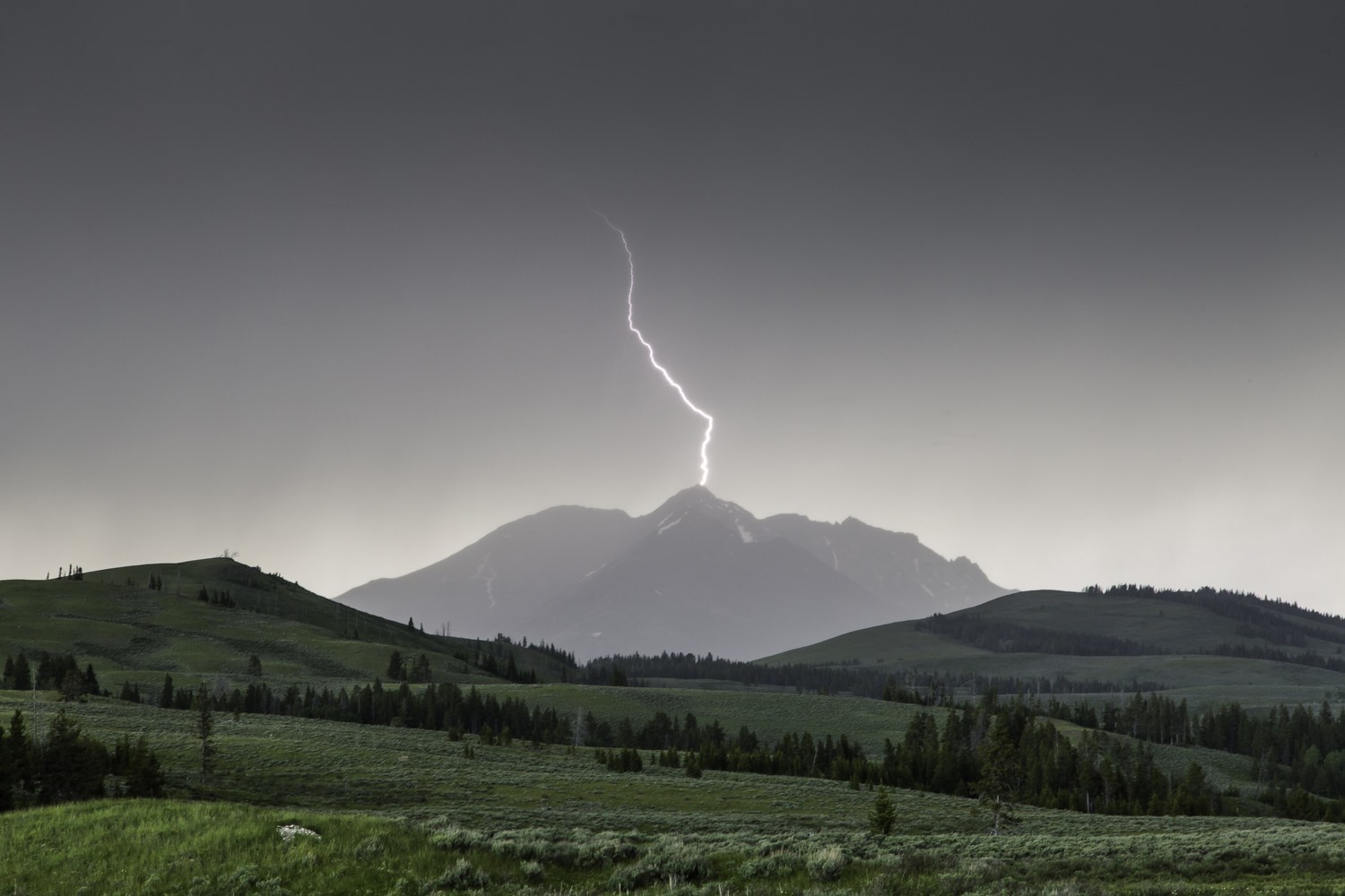 A thunderstorm at sunset over Swan Lake Flat, most of the frame sky.